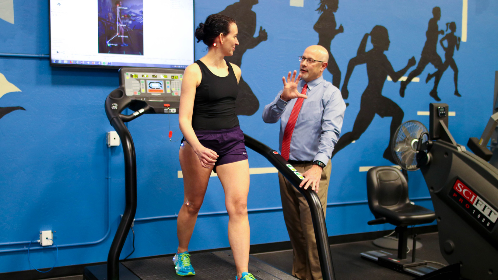 Women in Treadmills while talking to a Physical Therapist