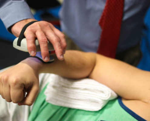 Physical Therapist using a device for a patient